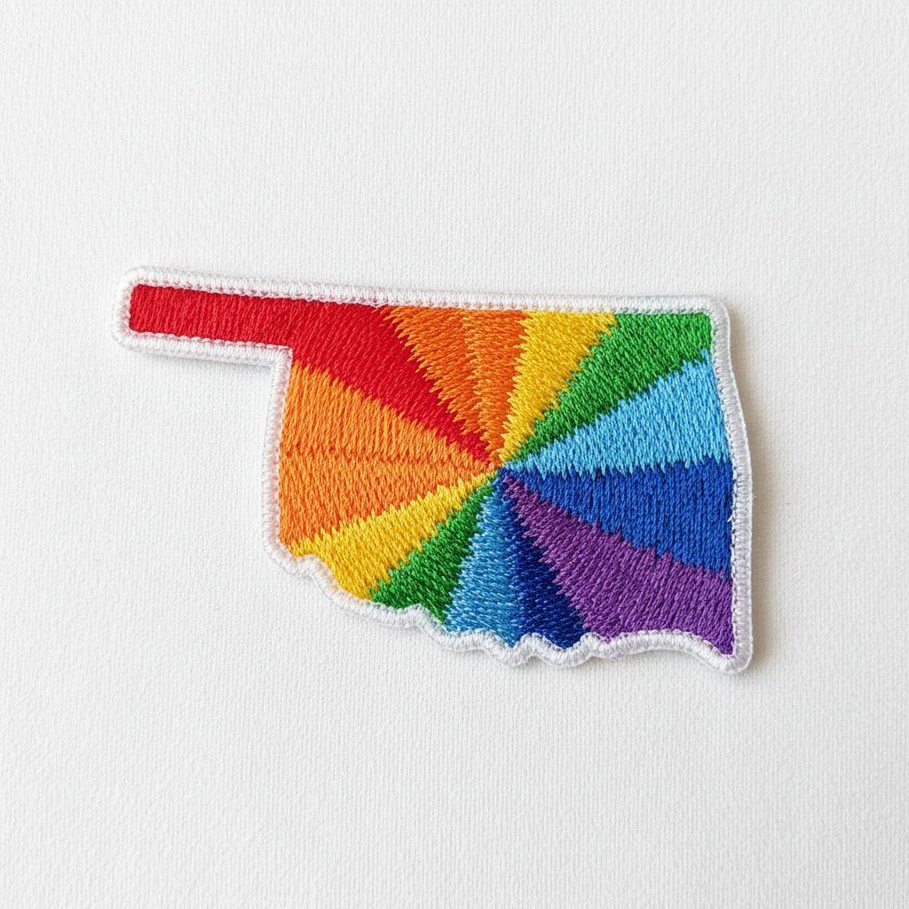 Embroidered iron-on patch in the shape of Oklahoma filled with vibrant rainbow colors